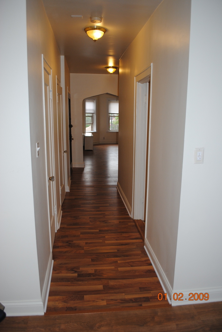 7635 South Yates Boulevard Chicago, IL 60649 - Photo 10 of 17 a view of a hallway with wooden floor