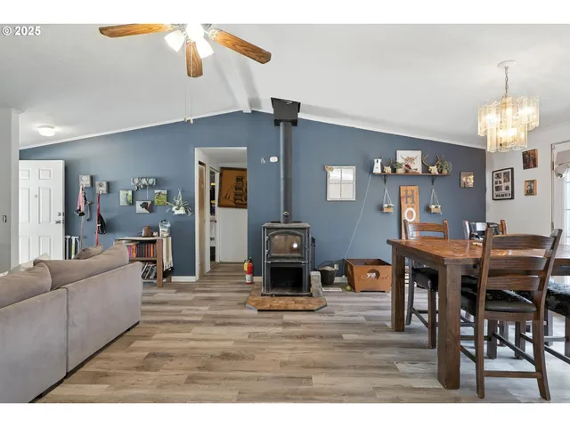 a living room with furniture a dining table and a chandelier