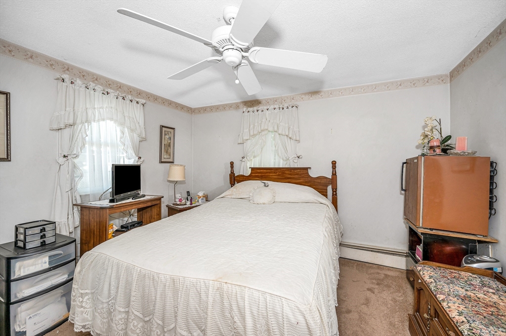 19 Reo Road Maynard, MA 01754 - Photo 11 of 41 a bedroom with a bed and a flat screen tv