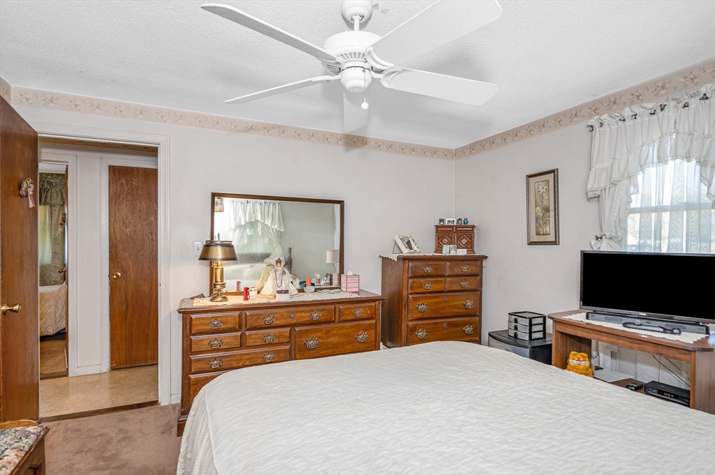 19 Reo Road Maynard, MA 01754 - Photo 13 of 41 a bedroom with a bed and a flat screen tv