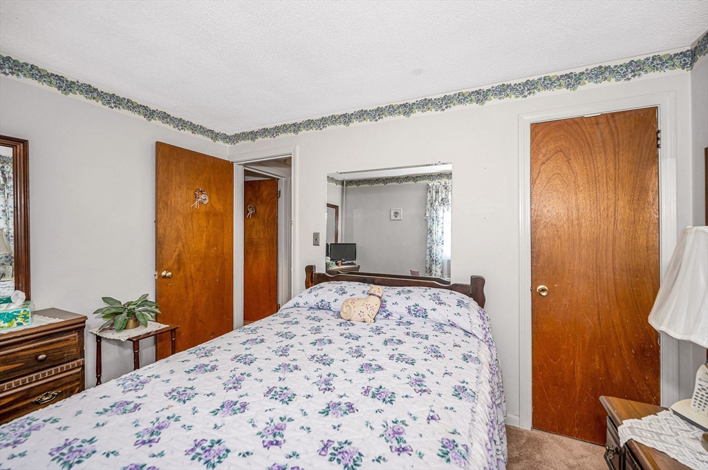 19 Reo Road Maynard, MA 01754 - Photo 15 of 41 a bedroom with a bed and a dresser