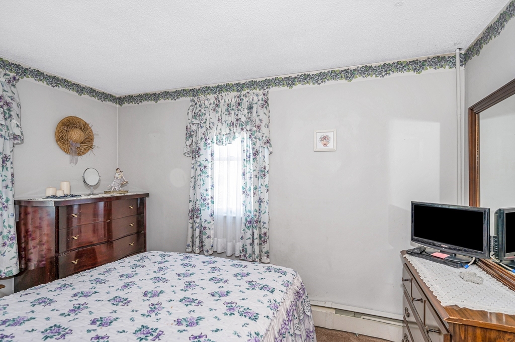 19 Reo Road Maynard, MA 01754 - Photo 16 of 41 a bedroom with a bed and a window