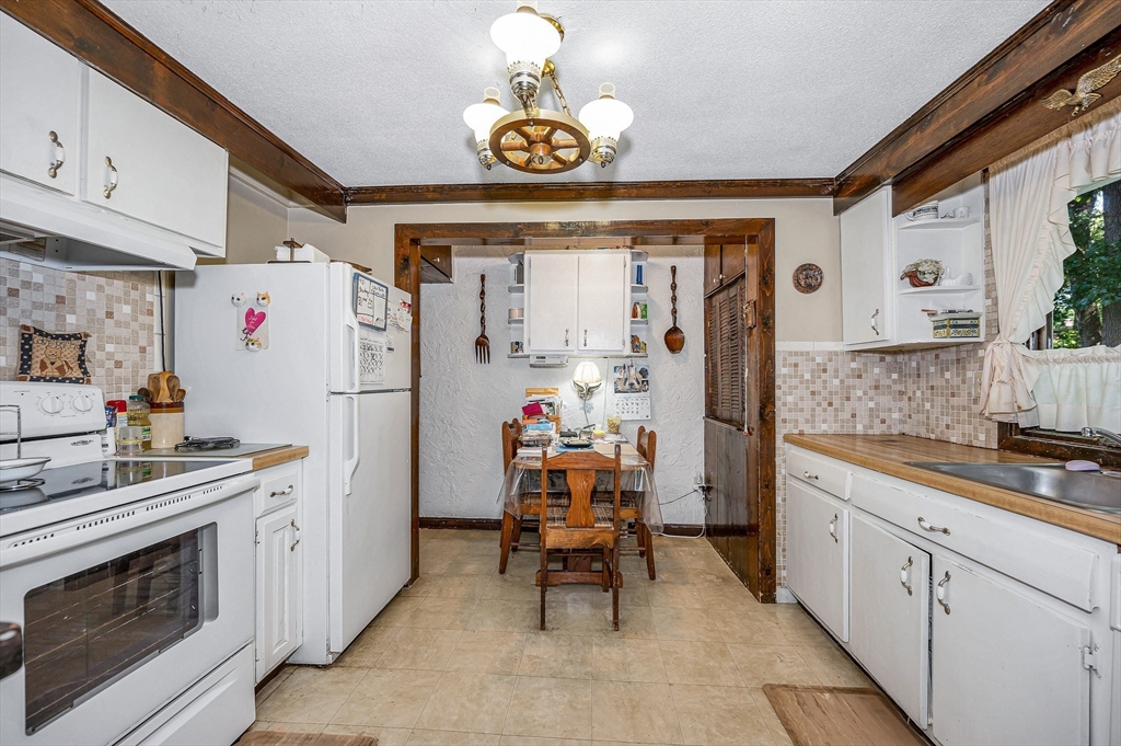 19 Reo Road Maynard, MA 01754 - Photo 20 of 41 a kitchen with a refrigerator and a stove