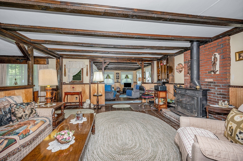 19 Reo Road Maynard, MA 01754 - Photo 27 of 41 a living room with furniture and a floor to ceiling window