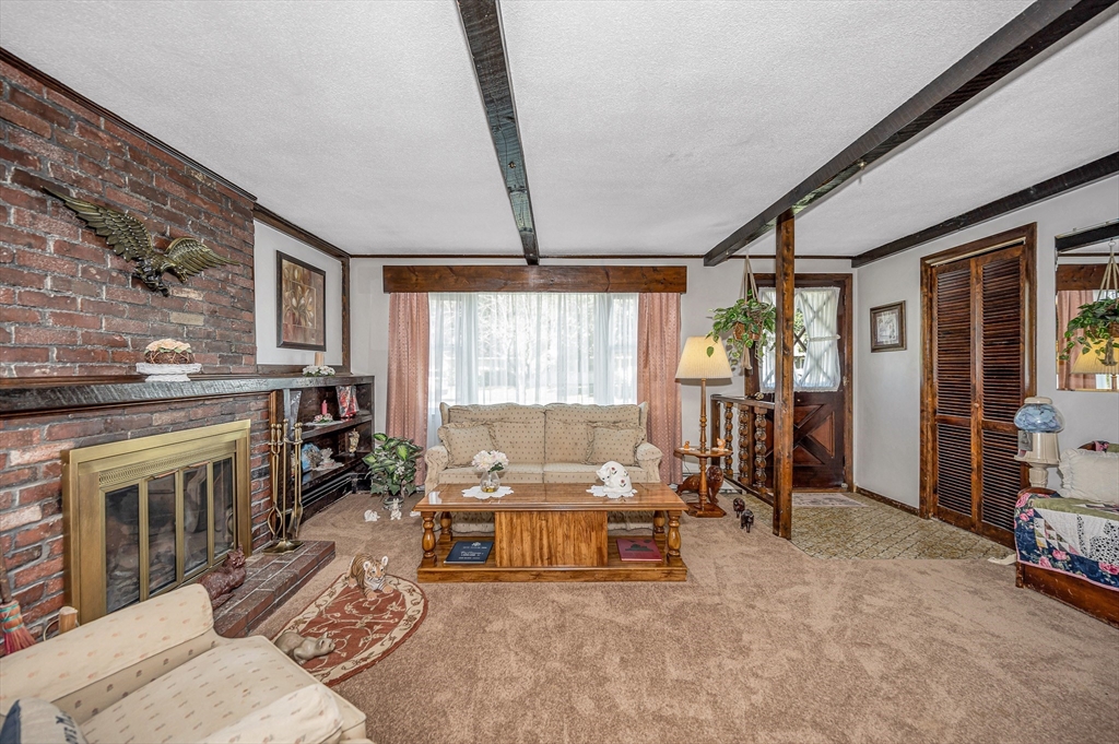 19 Reo Road Maynard, MA 01754 - Photo 3 of 41 a living room with furniture and a fireplace