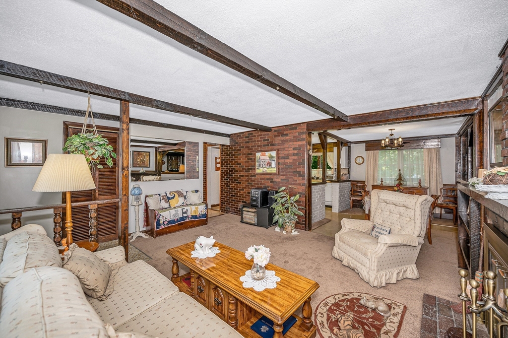 19 Reo Road Maynard, MA 01754 - Photo 6 of 41 a living room with furniture and a lamp