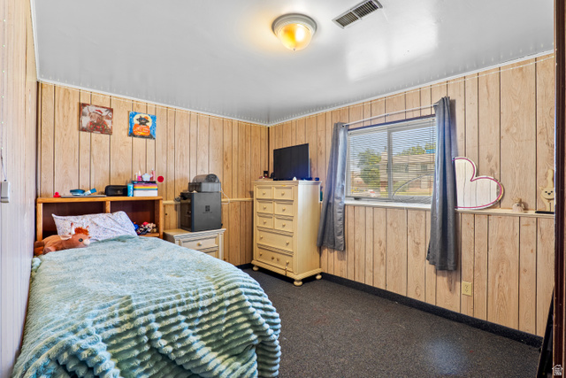 2327 880 North Provo, UT 84601 - Photo 11 of 15 Room featuring wood-finish paneling, dark carpeting, and a window with blinds