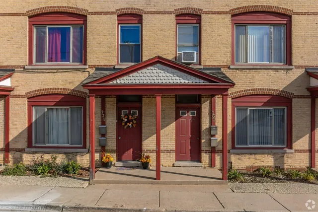 a view of a house with brick walls