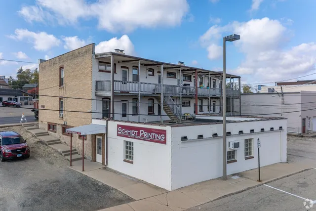 a front view of a building with parking space