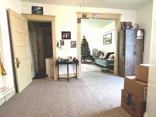 a view of livingroom with furniture and refrigerator
