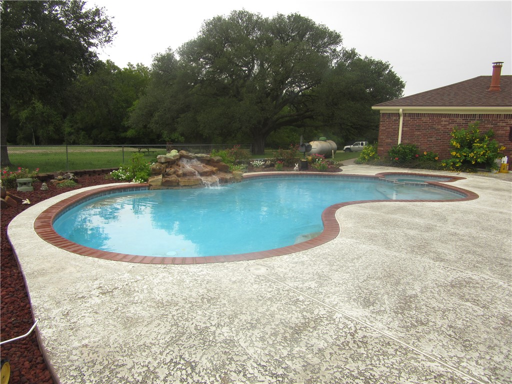a view of a swimming pool with a yard