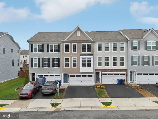 a front view of a building with car parked