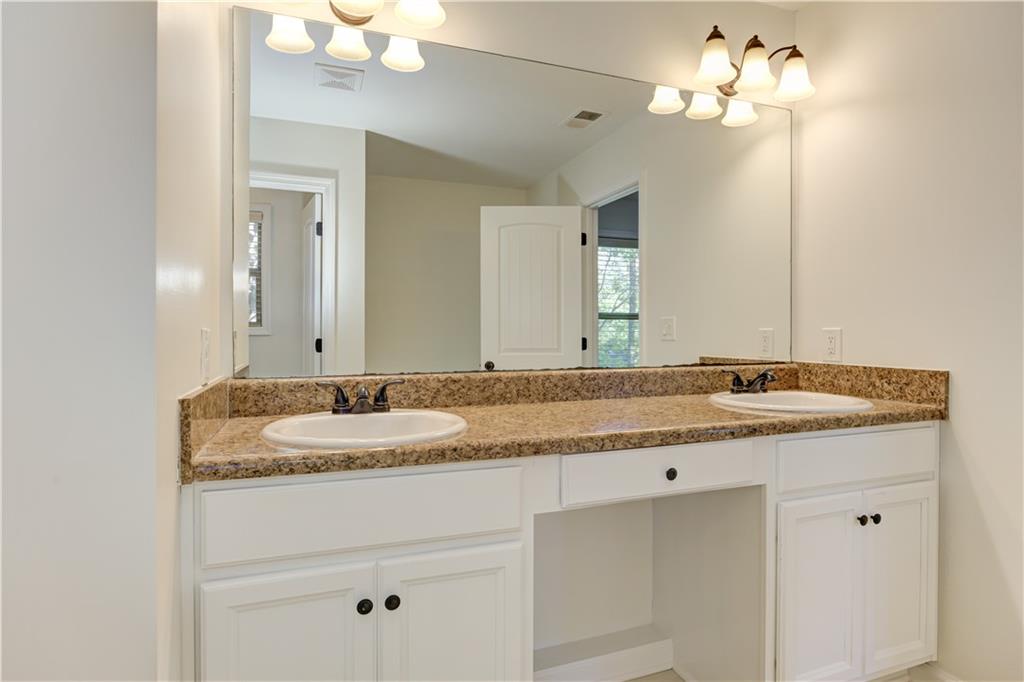 605 Summit Point Canton, GA 30114 - Photo 33 of 56 a bathroom with a granite countertop double vanity and a mirror