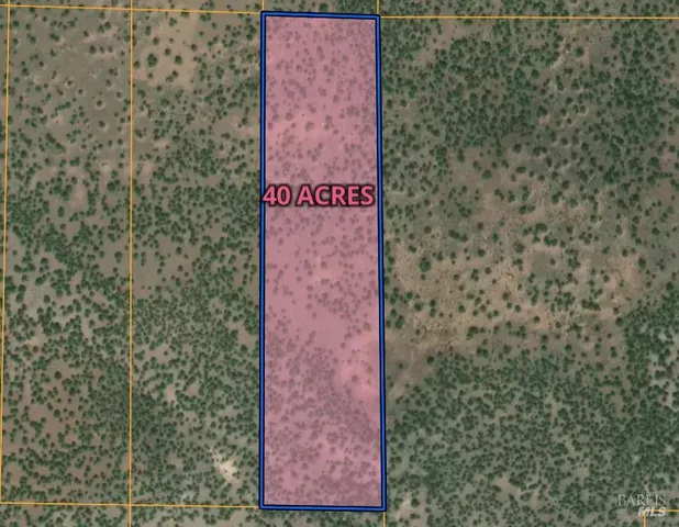 a sign that is sitting in front of a brick wall