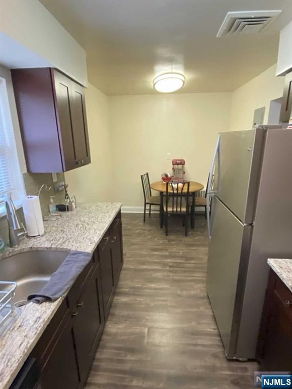 280-320 Oak Street, Unit 320C Ridgewood, NJ 07450 - Photo 11 of 25 a kitchen with stainless steel appliances granite countertop a sink refrigerator and cabinets