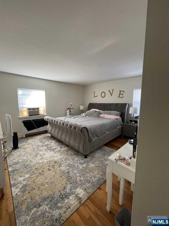 280-320 Oak Street, Unit 320C Ridgewood, NJ 07450 - Photo 16 of 25 a bedroom with a bed and a flat screen tv