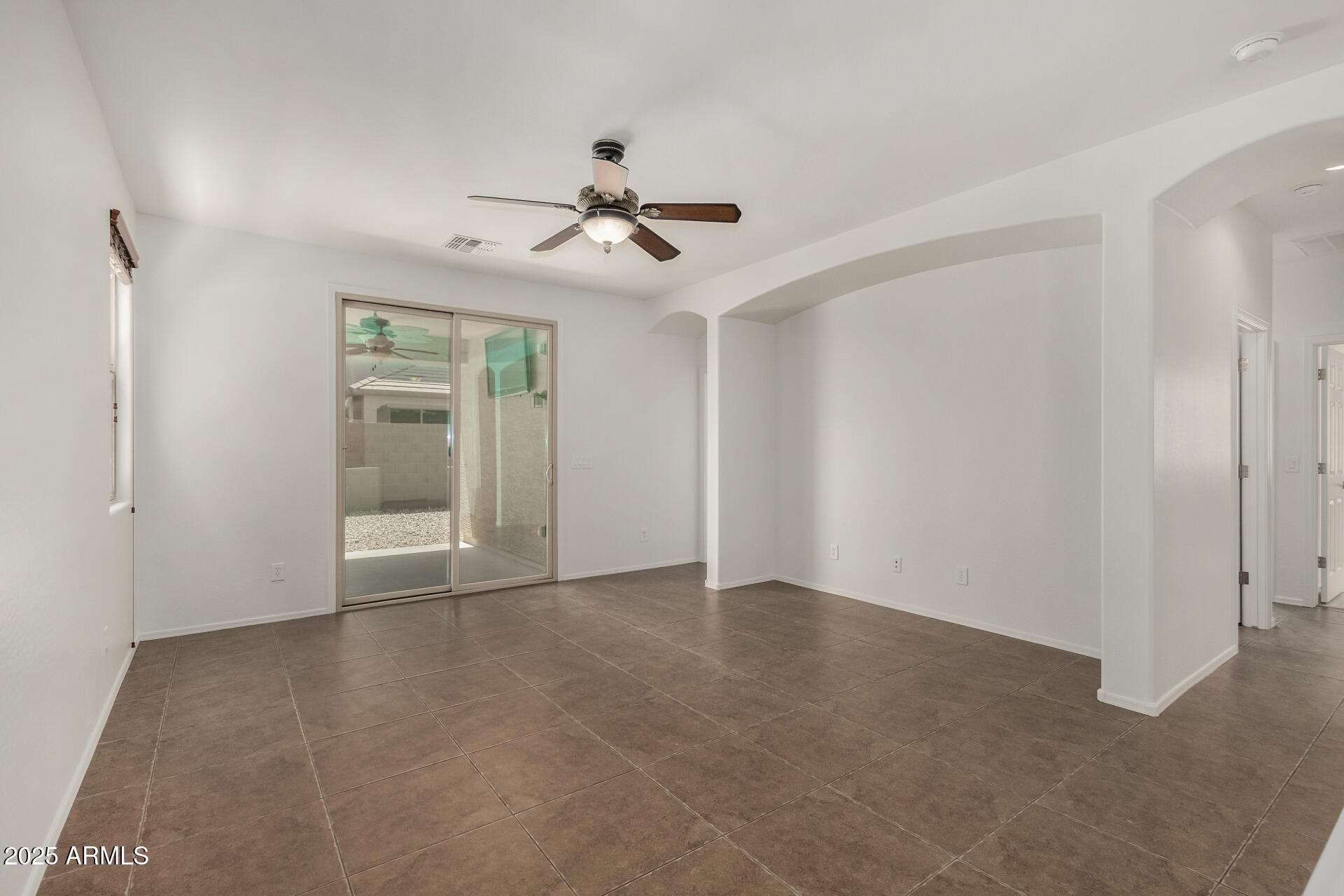 3313 West Gran Paradiso Drive Phoenix, AZ 85086 - Photo 11 of 31 a view of an empty room with a ceiling fan