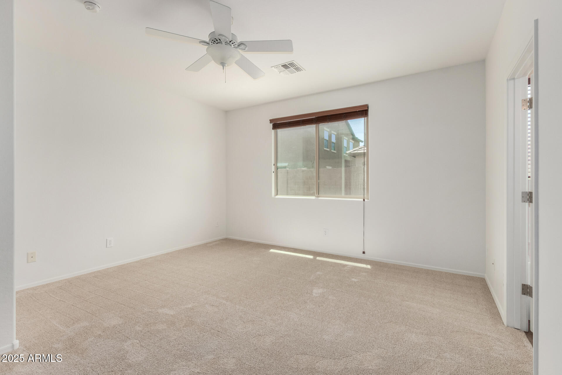 3313 West Gran Paradiso Drive Phoenix, AZ 85086 - Photo 13 of 31 an empty room with windows and fan