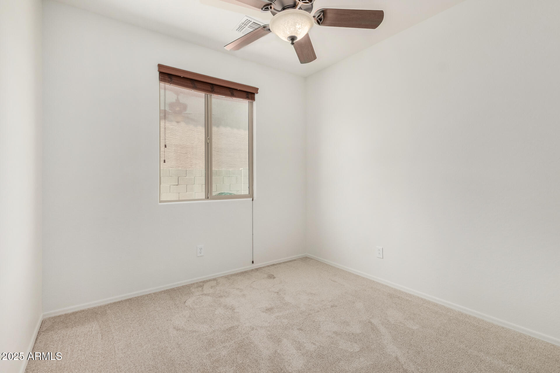 3313 West Gran Paradiso Drive Phoenix, AZ 85086 - Photo 20 of 31 an empty room with a window and a fan