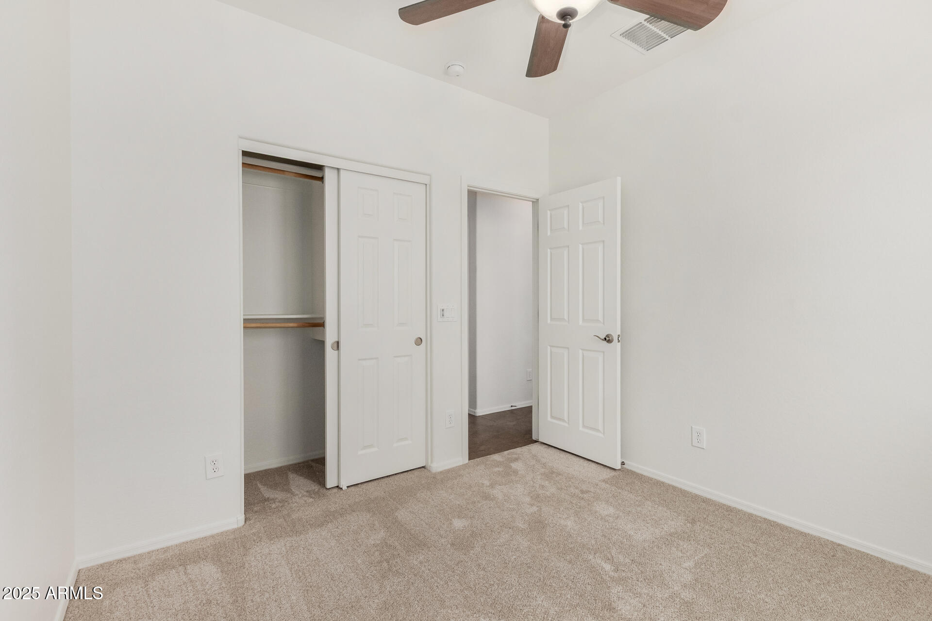 3313 West Gran Paradiso Drive Phoenix, AZ 85086 - Photo 21 of 31 an empty room with a ceiling fan and a bathroom