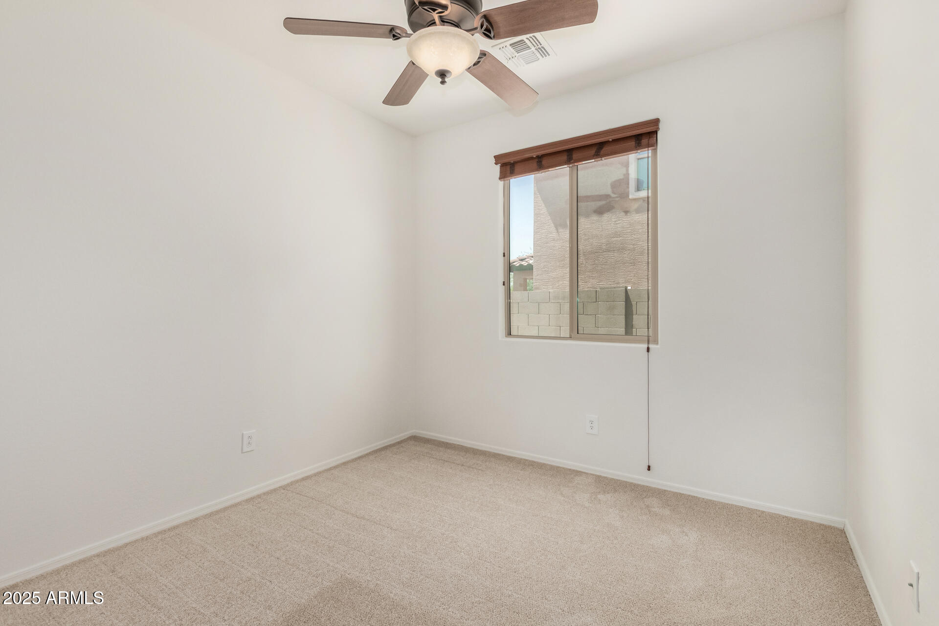 3313 West Gran Paradiso Drive Phoenix, AZ 85086 - Photo 22 of 31 an empty room with a window and a fan