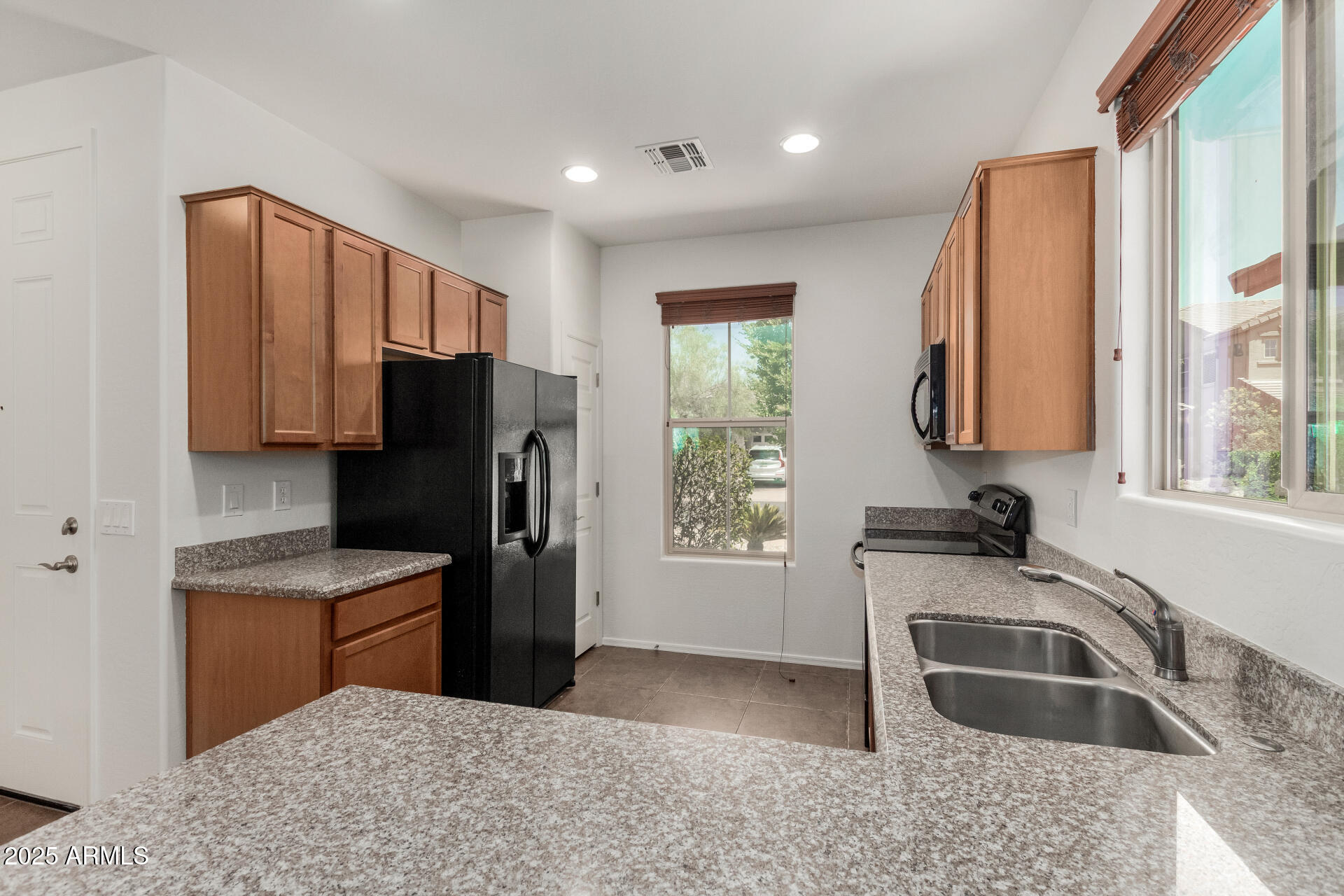 3313 West Gran Paradiso Drive Phoenix, AZ 85086 - Photo 4 of 31 a kitchen with stainless steel appliances granite countertop a sink stove and refrigerator