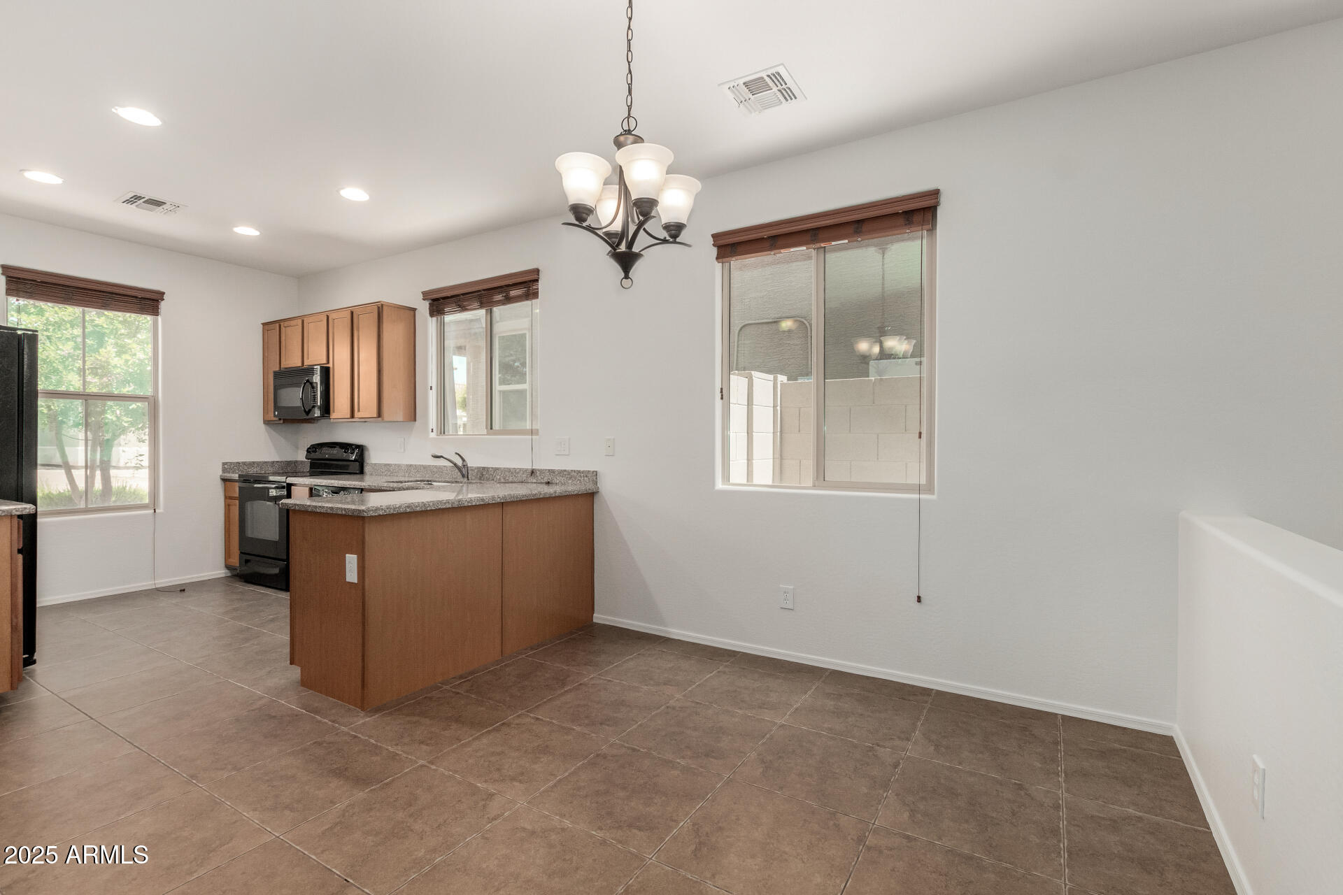 3313 West Gran Paradiso Drive Phoenix, AZ 85086 - Photo 5 of 31 a kitchen with granite countertop a sink cabinets and window