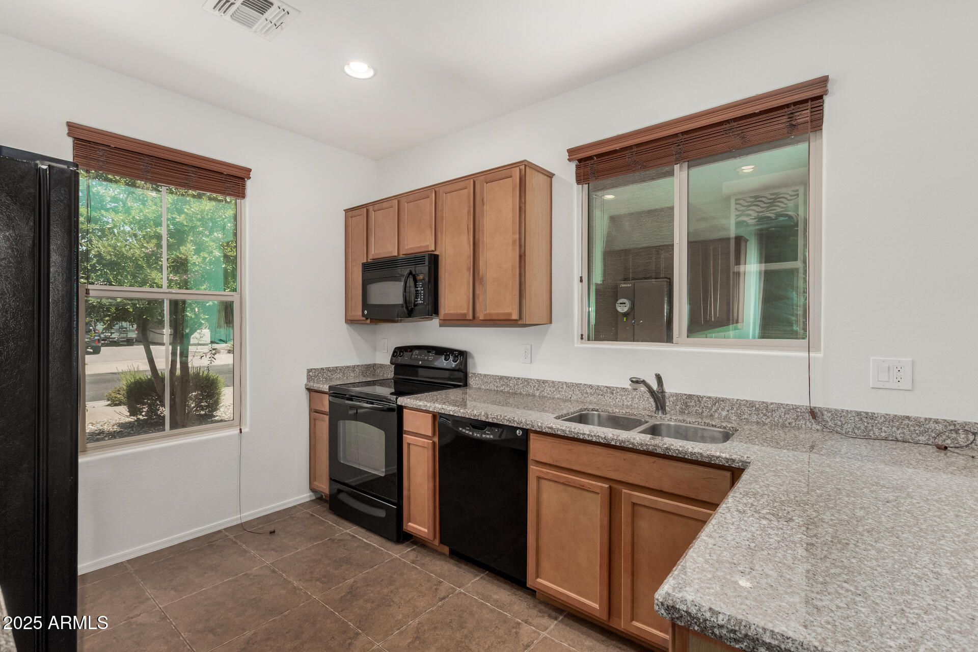 3313 West Gran Paradiso Drive Phoenix, AZ 85086 - Photo 7 of 31 a kitchen with granite countertop a stove sink and microwave