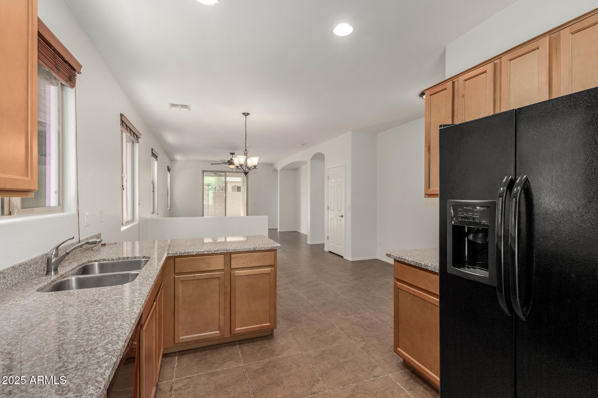 3313 West Gran Paradiso Drive Phoenix, AZ 85086 - Photo 8 of 31 a kitchen with granite countertop a sink stove and refrigerator