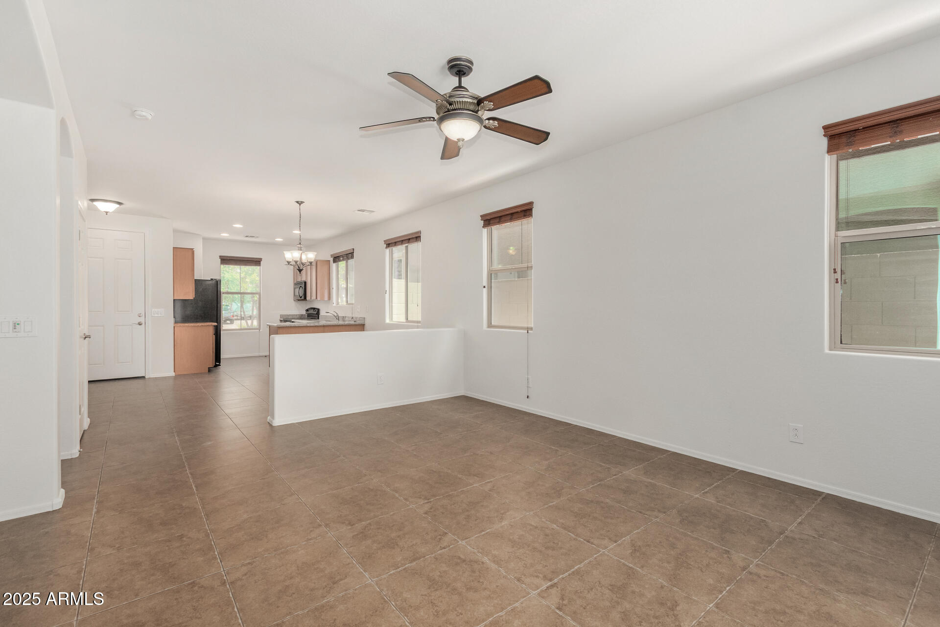 3313 West Gran Paradiso Drive Phoenix, AZ 85086 - Photo 9 of 31 a view of a livingroom with a ceiling fan and wooden floor