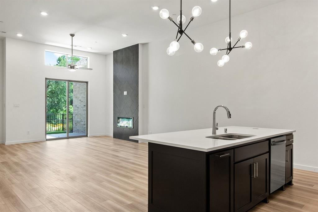 8513 Del Rio Trail Wylie, TX 75098 - Photo 13 of 33 a kitchen with a sink chandelier and wooden floor