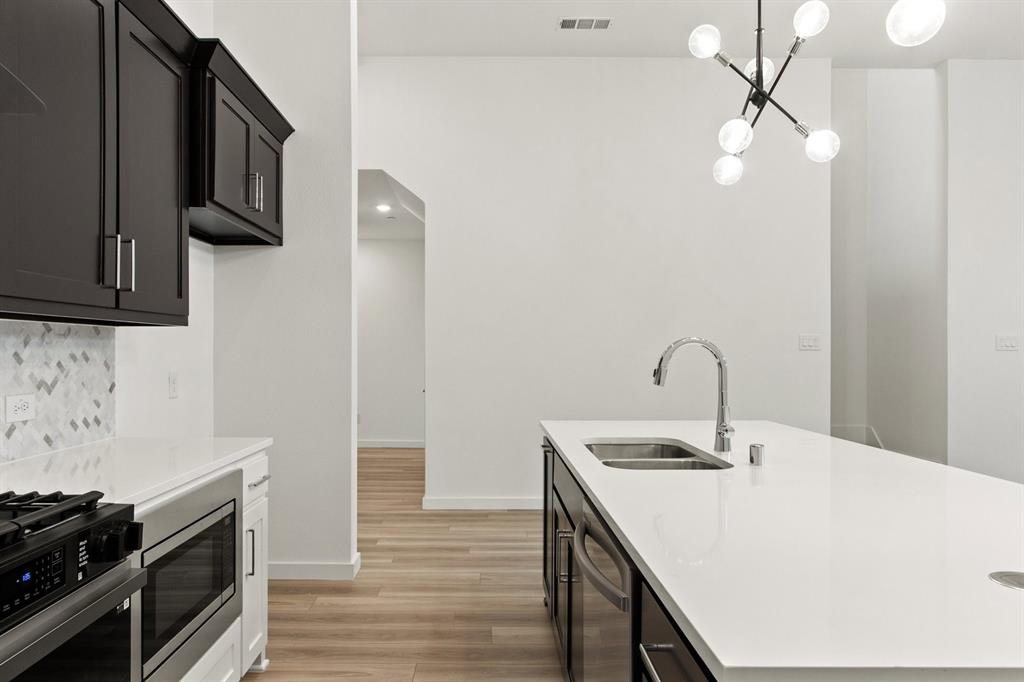8513 Del Rio Trail Wylie, TX 75098 - Photo 14 of 33 a kitchen with a sink cabinets and stainless steel appliances