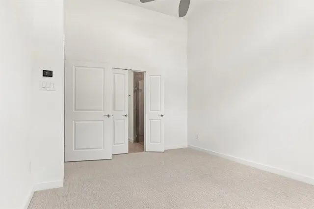 a spacious bathroom with a granite countertop sink a mirror and shower