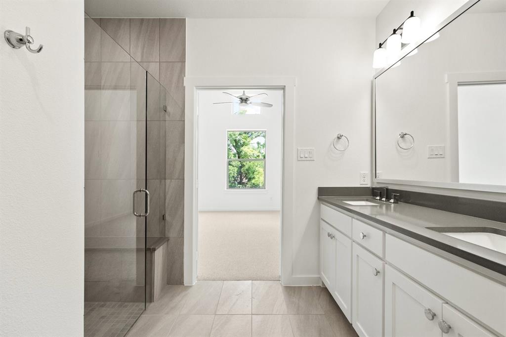 8513 Del Rio Trail Wylie, TX 75098 - Photo 22 of 33 a bathroom with a granite countertop sink a mirror and a shower