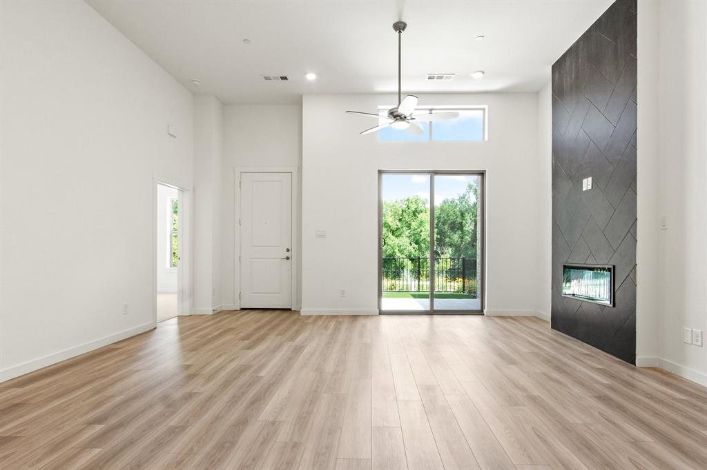 8513 Del Rio Trail Wylie, TX 75098 - Photo 7 of 33 a view of an empty room with a window and wooden floor