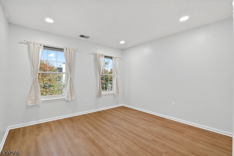 3509 French Drive, Unit 9 Bridgewater, NJ 08807 - Photo 16 of 22 an empty room with wooden floor and windows