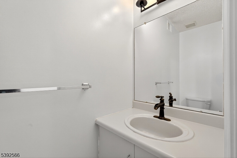 3509 French Drive, Unit 9 Bridgewater, NJ 08807 - Photo 10 of 22 a bathroom with a sink and mirror