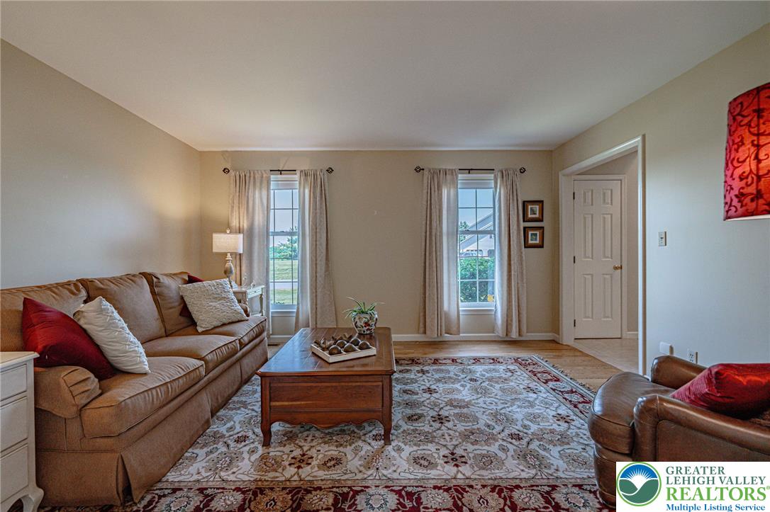 4542 Springfield Drive Coplay, PA 18037 - Photo 33 of 89 A warm and inviting living room features large windows and rich hardwood flooring.