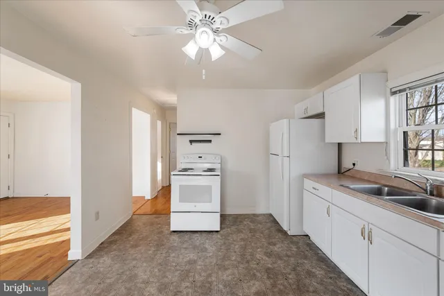 a kitchen with cabinets and stainless steel appliances
