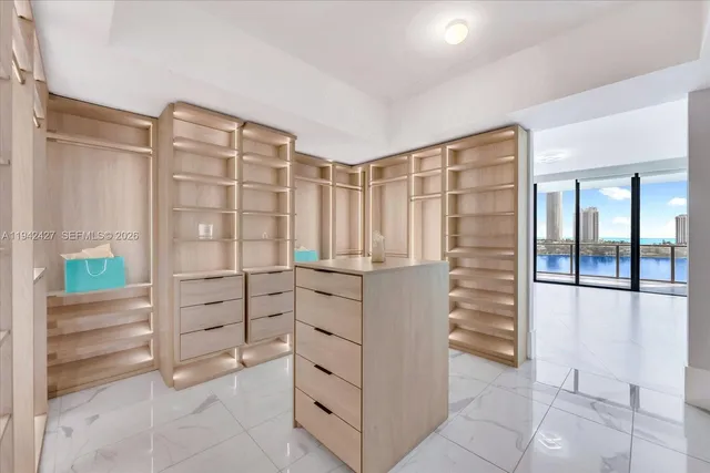 a view of walk in closet with cabinet