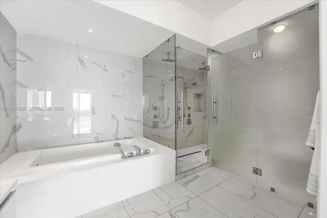 a bathroom with a bathtub and a shower