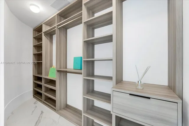 a view of walk in closet with empty racks