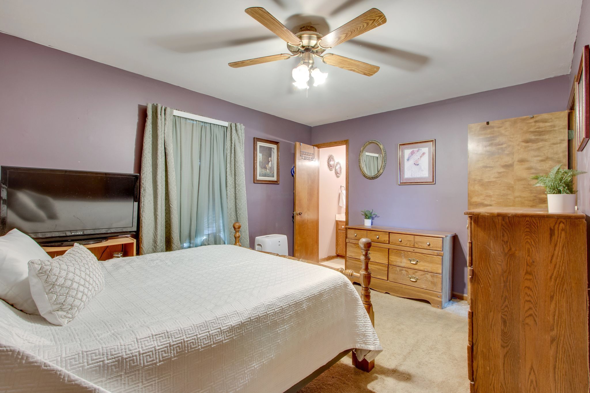 207 Eaton Heights Manchester, TN 37355 - Photo 21 of 37 a bedroom with a bed and a chandelier