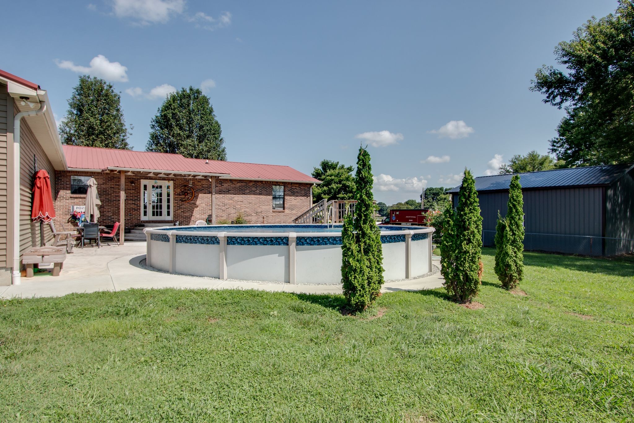 207 Eaton Heights Manchester, TN 37355 - Photo 33 of 37 a white house with a yard and a large tree