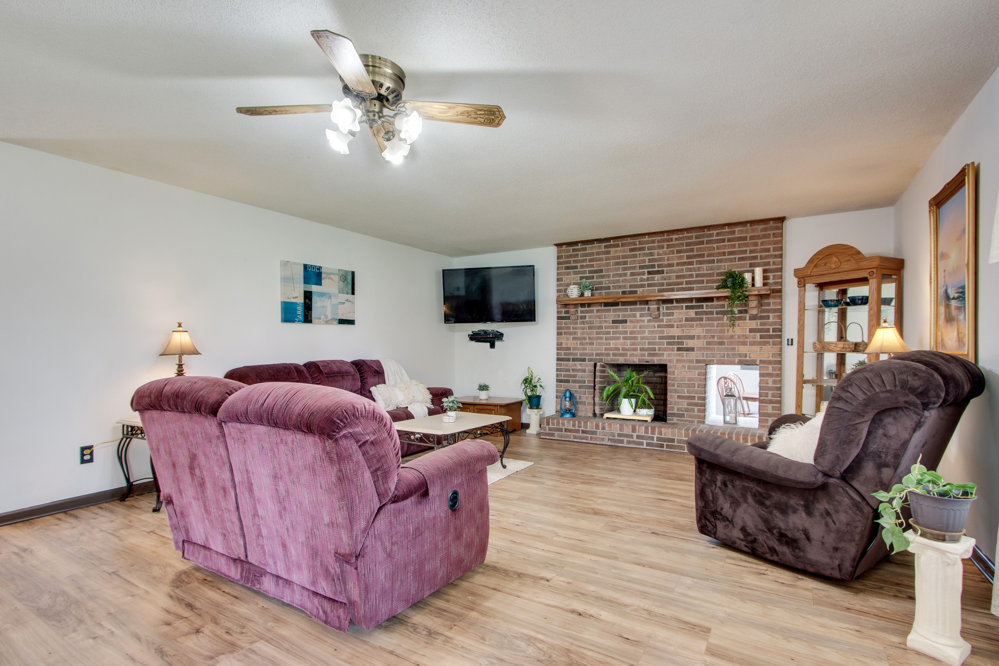207 Eaton Heights Manchester, TN 37355 - Photo 8 of 37 a living room with furniture a fireplace and a flat screen tv