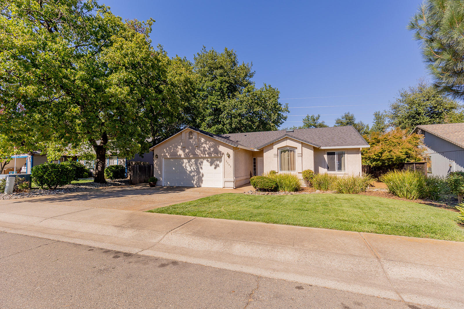 3363 Lawrence Road Redding, CA 96002 - Photo 3 of 33 a front view of a house with a yard and garage