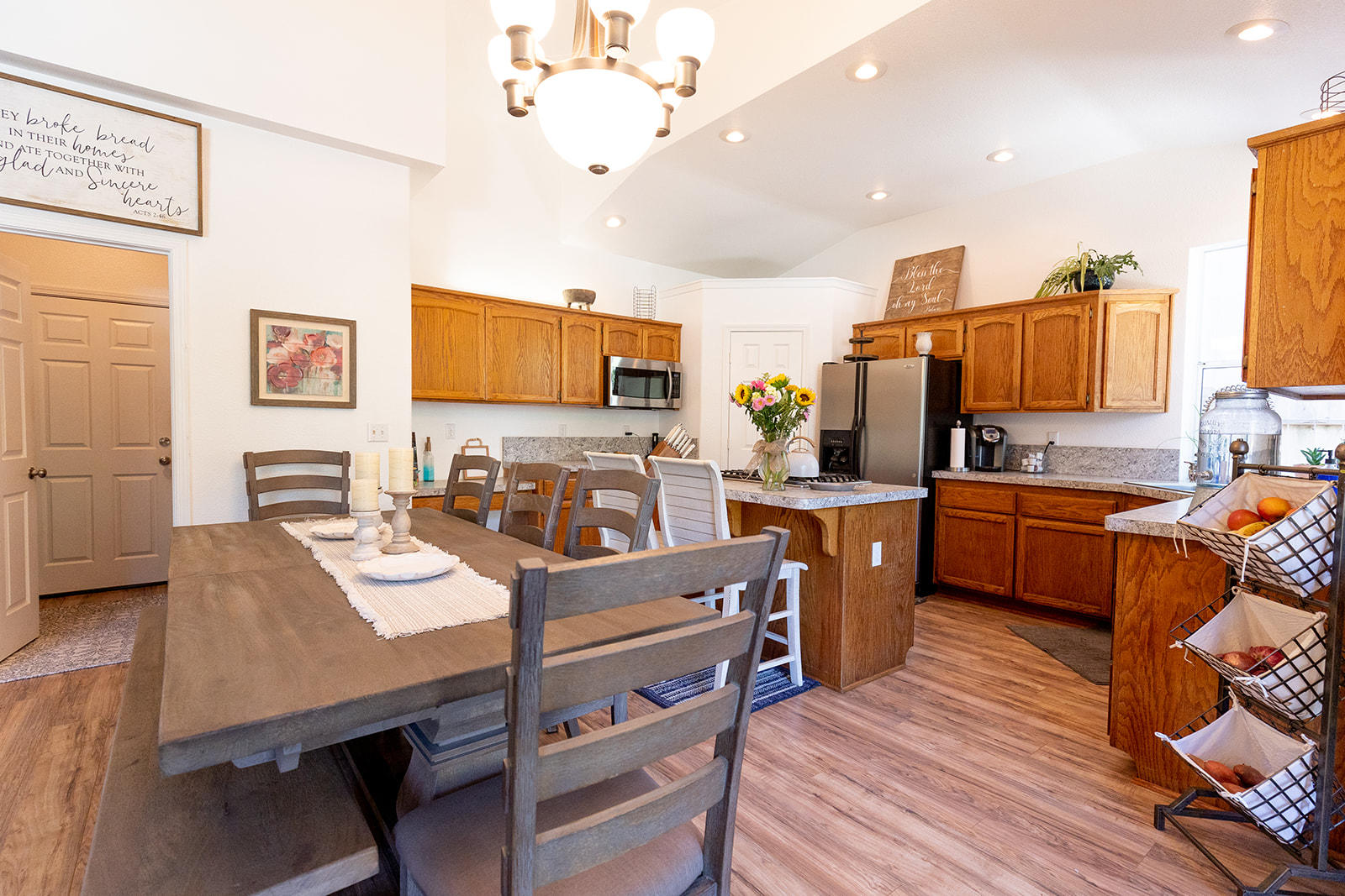 3363 Lawrence Road Redding, CA 96002 - Photo 10 of 33 a open kitchen with stainless steel appliances granite countertop a stove top oven a sink dishwasher a dining table and chairs with wooden floor