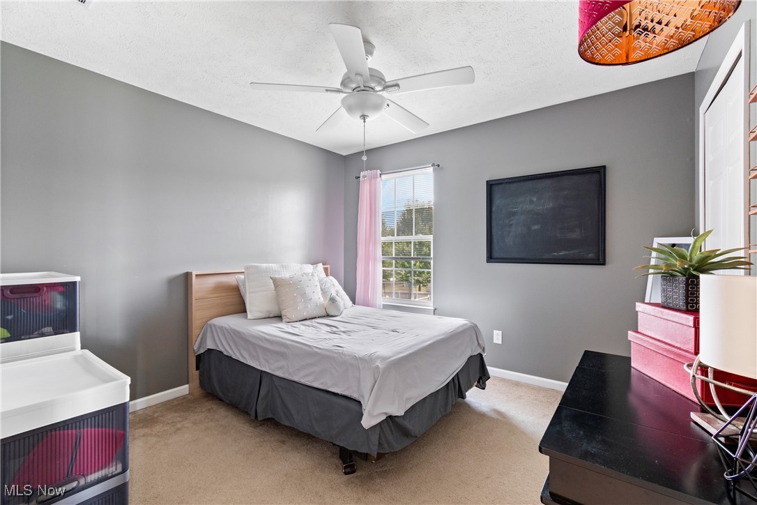 4467 Ridgestone Way Medina, OH 44256 - Photo 18 of 31 Carpeted bedroom featuring a textured ceiling and ceiling fan