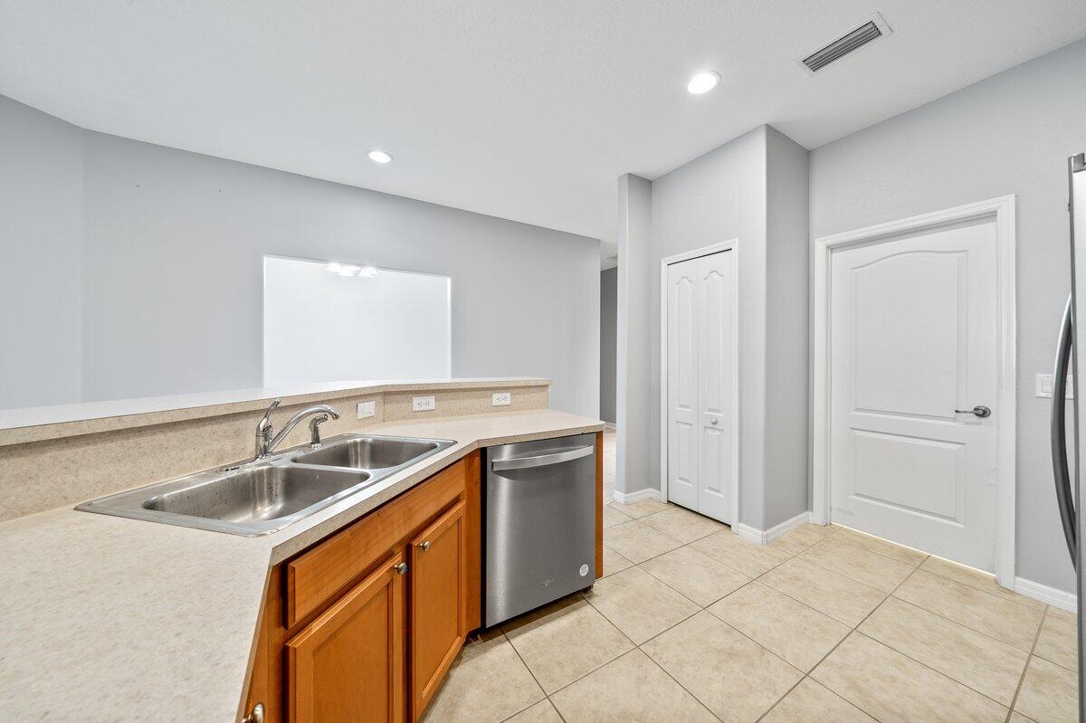 2980 Le Conte Street Melbourne, FL 32940 - Photo 11 of 25 a kitchen with a sink and a refrigerator