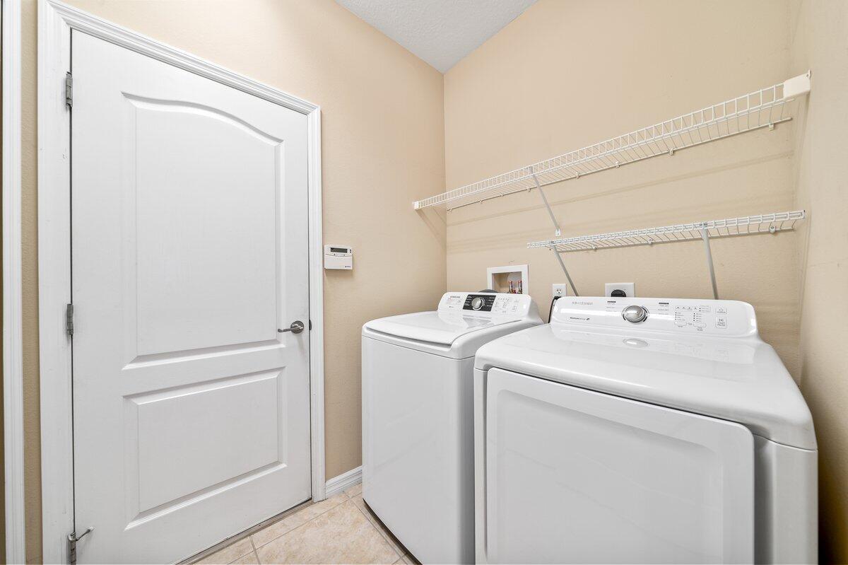 2980 Le Conte Street Melbourne, FL 32940 - Photo 12 of 25 a utility room with dryer and washer